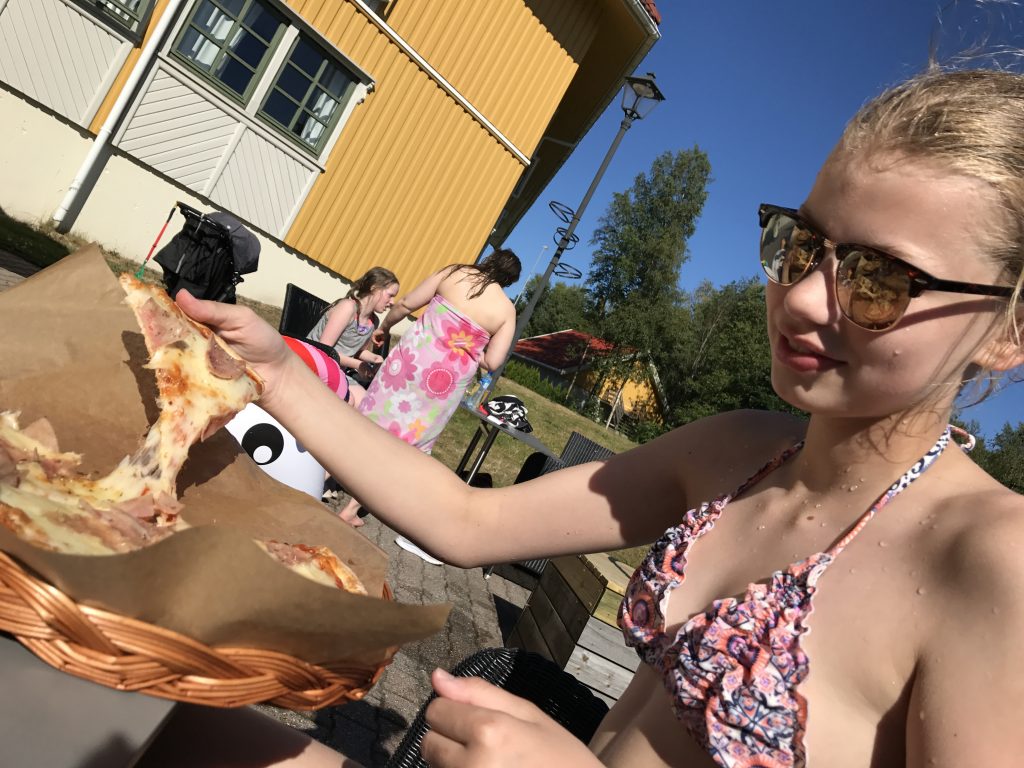 Jente spiser pizza på Scandic Sørlandet